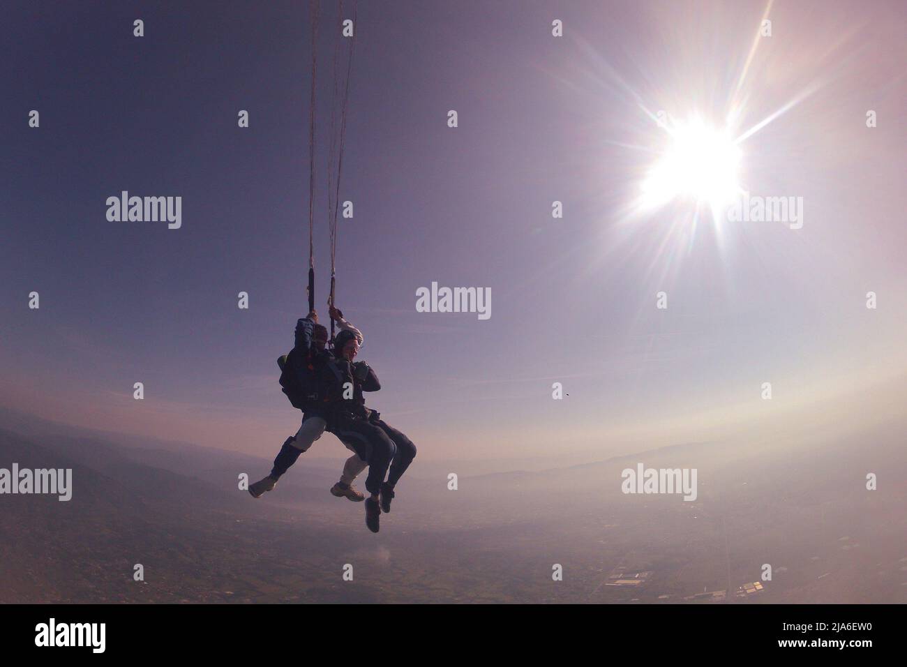 jump with an instructor in tandem in evening and  clear good weather, before sunset Stock Photo