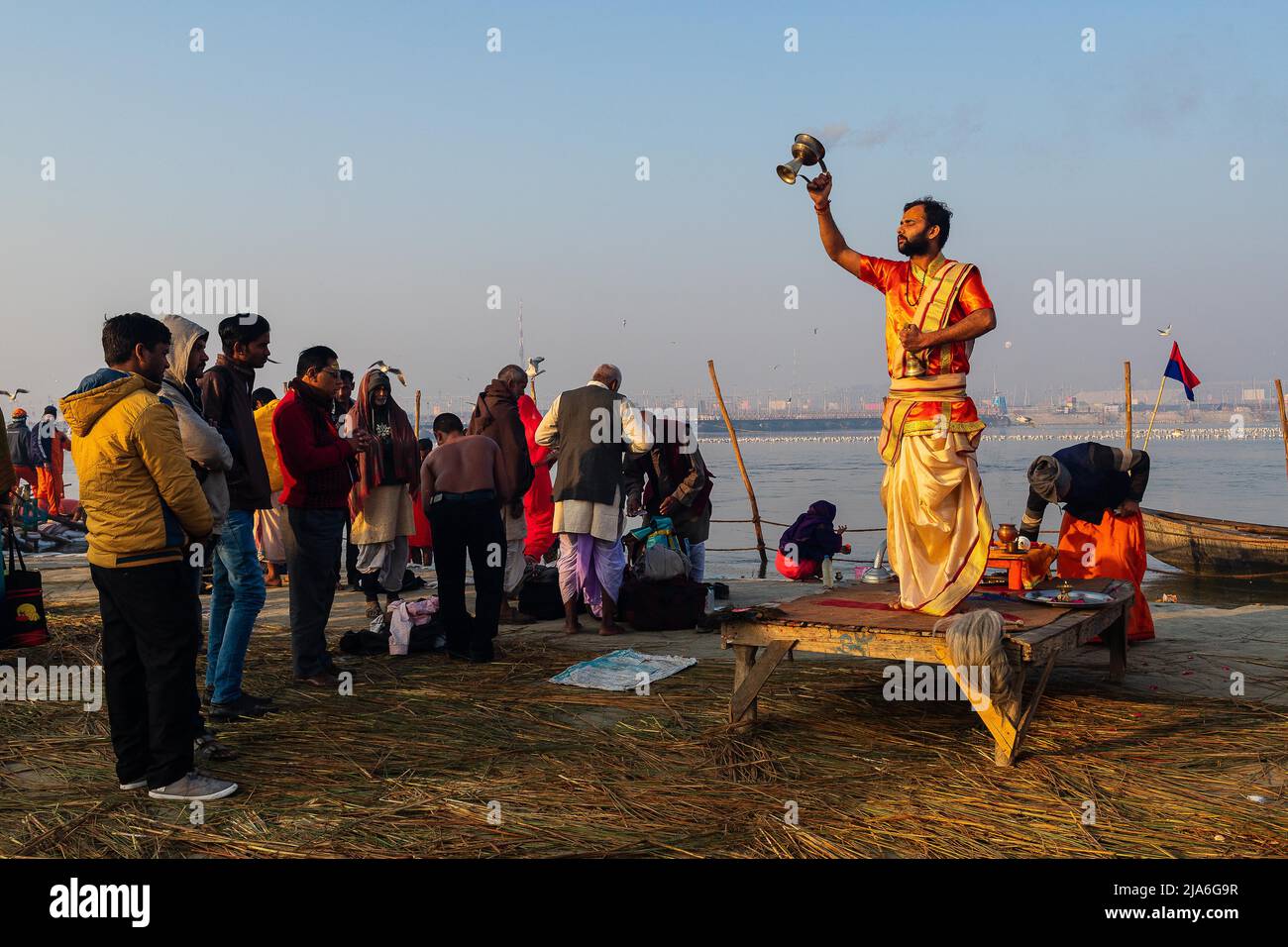 A sadhu performs a worship ritual during the morning on the banks of ...