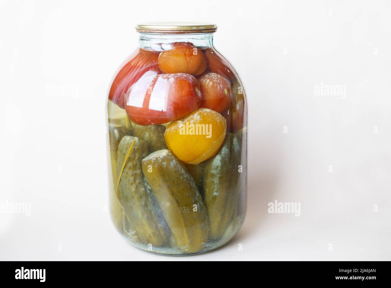 spoiled can of vegetable seaming. Glass jar with homemade pickled tomatos and cucumbers with white fungus and mold Stock Photo