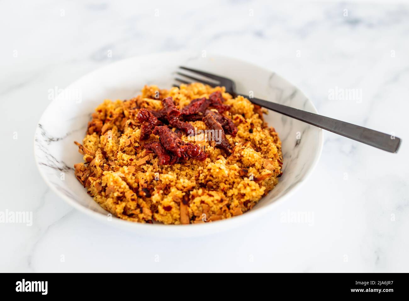 vegan couscous with sundried tomatoes and shredded tofu, healthy plant