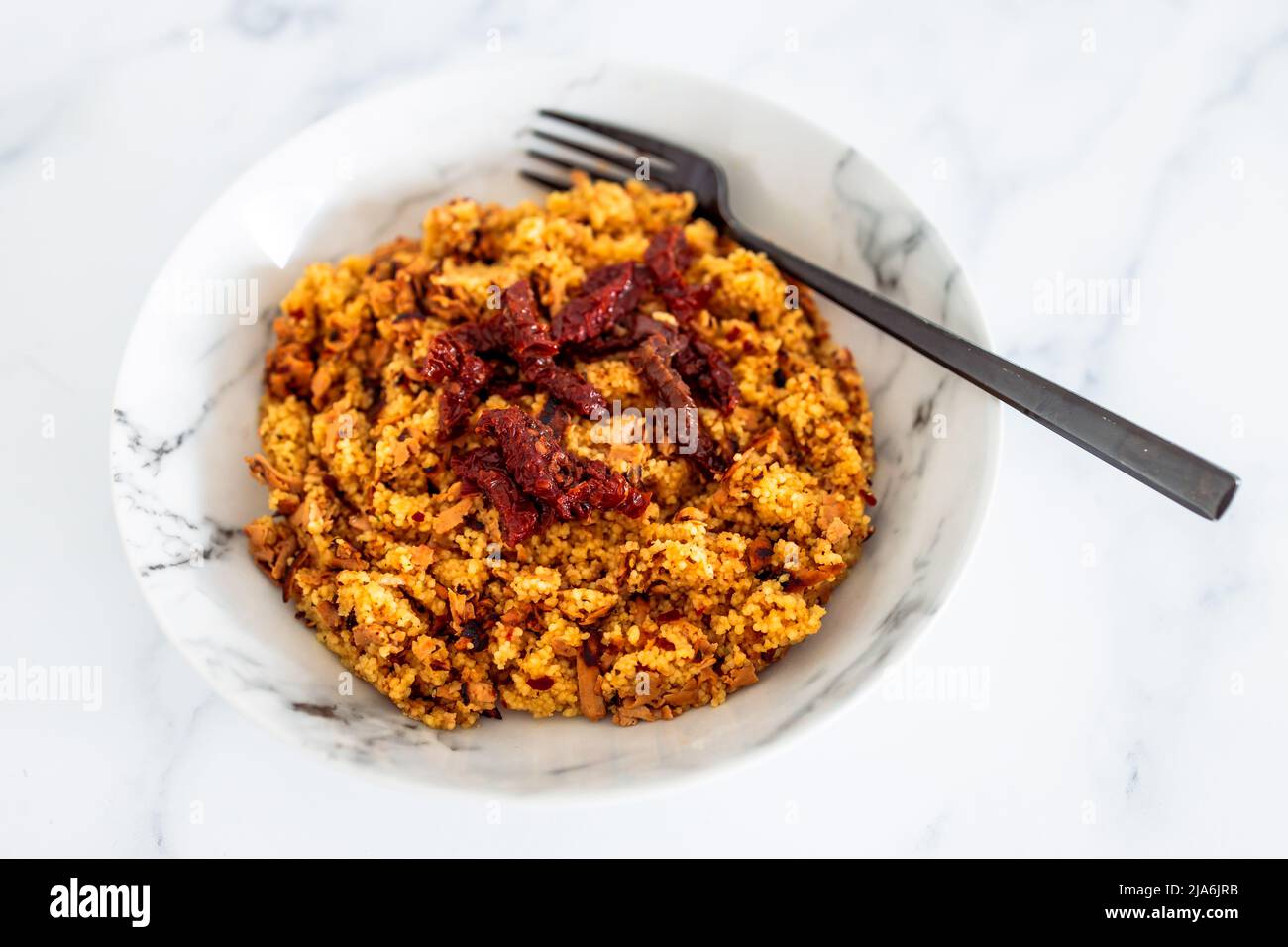 vegan couscous with sundried tomatoes and shredded tofu, healthy plant