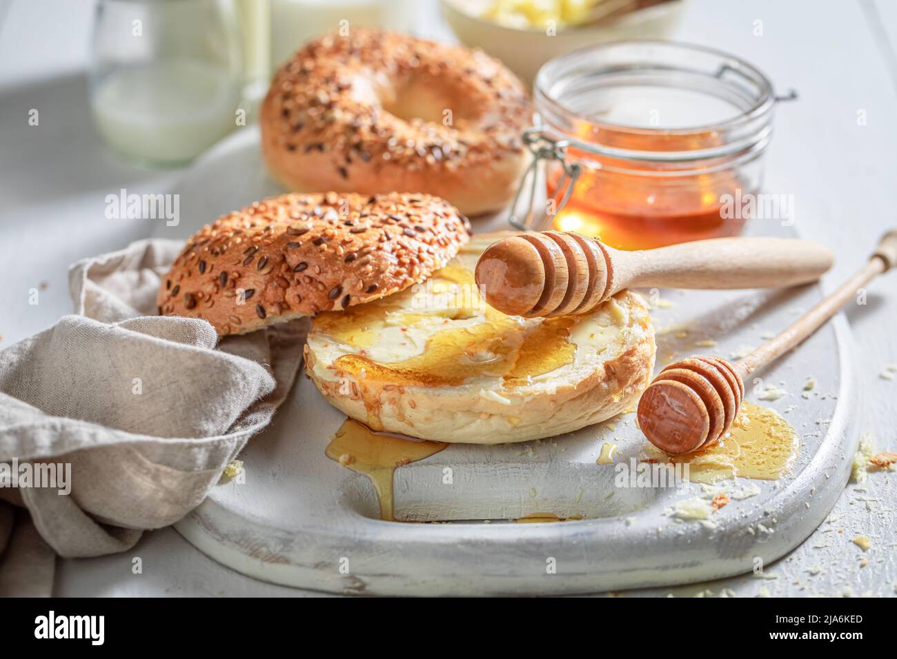 Hot and fresh golden bagels for tasty breakfast. Bagels with honey and