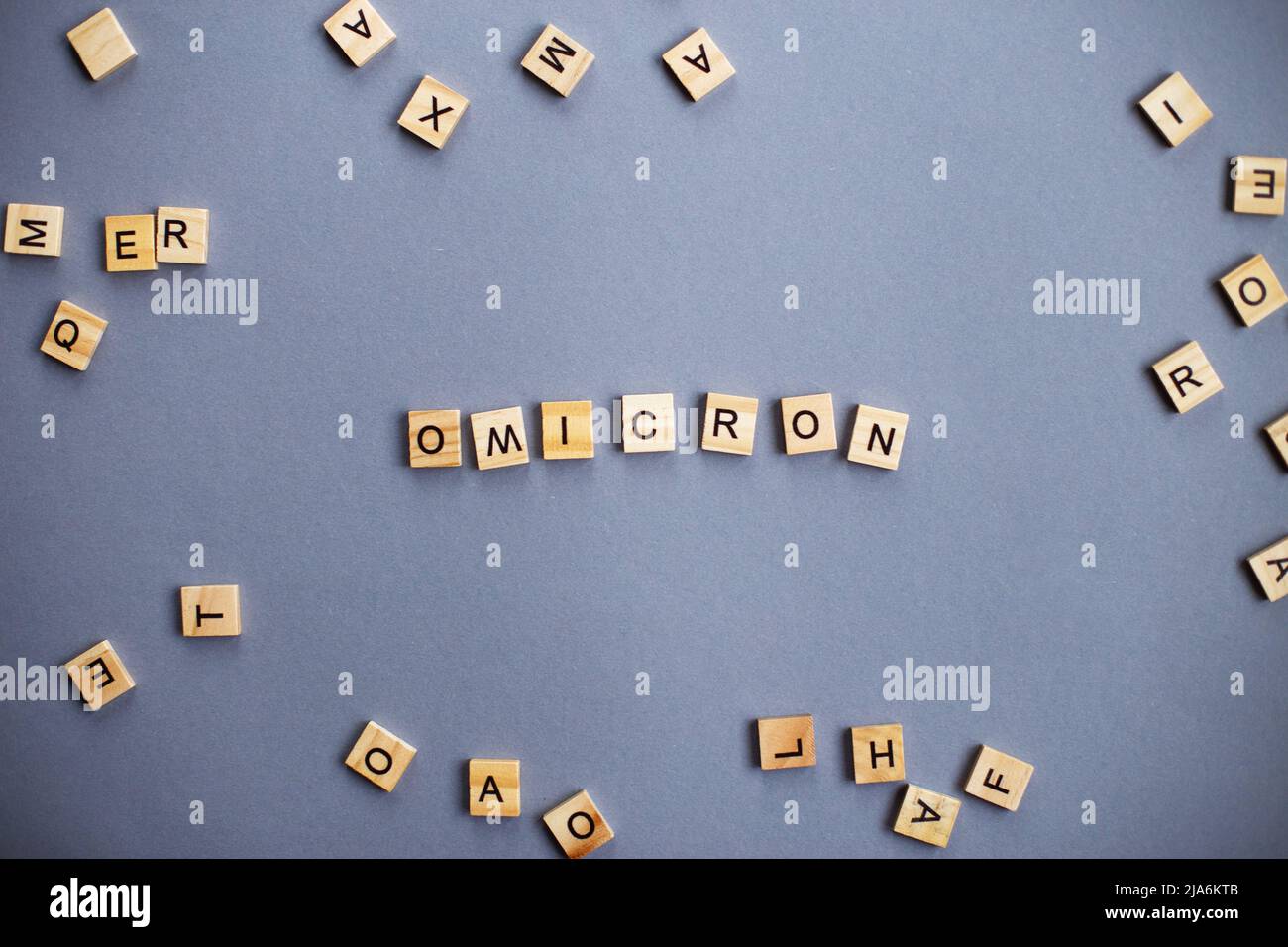 word omicron made by wooden blocks on gray background Stock Photo