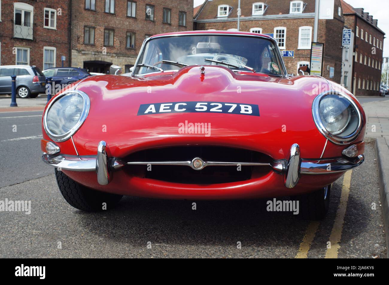 Front view of a red E-Type Jaguar sports car parked on the street Stock Photo