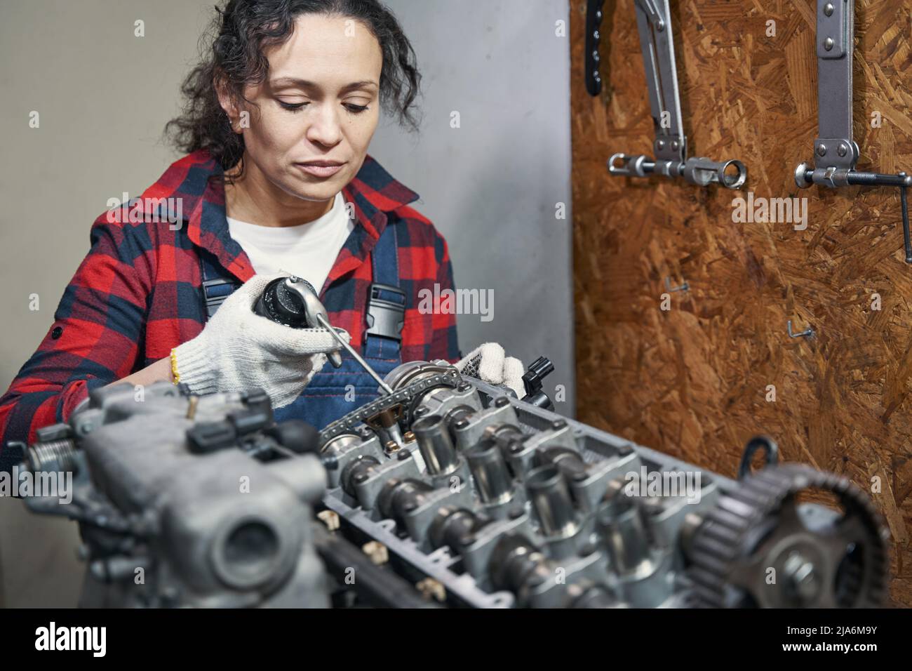 Female auto mechanic fixing car engine in garage Stock Photo Alamy