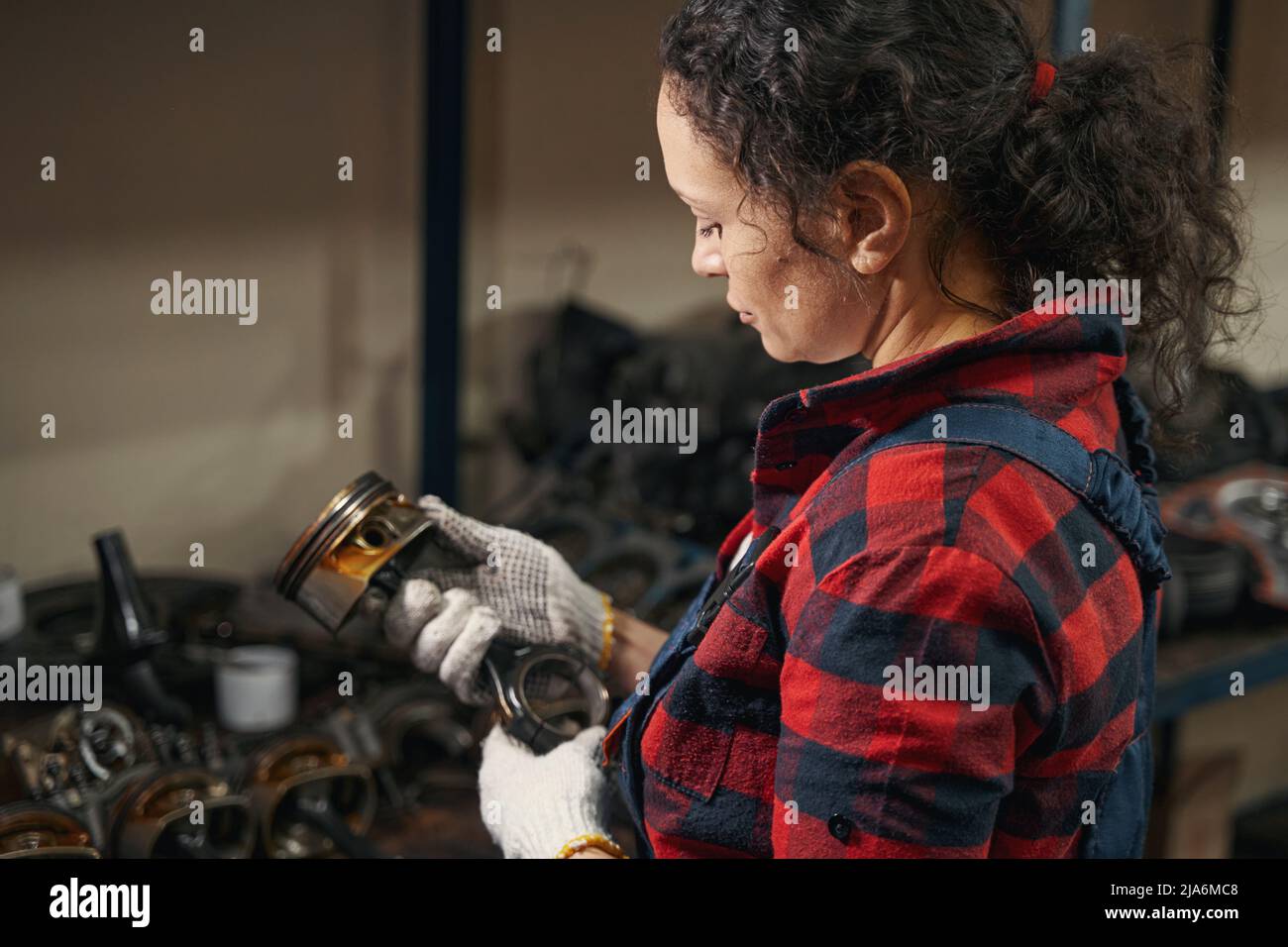 Female auto mechanic checking car parts in garage Stock Photo Alamy