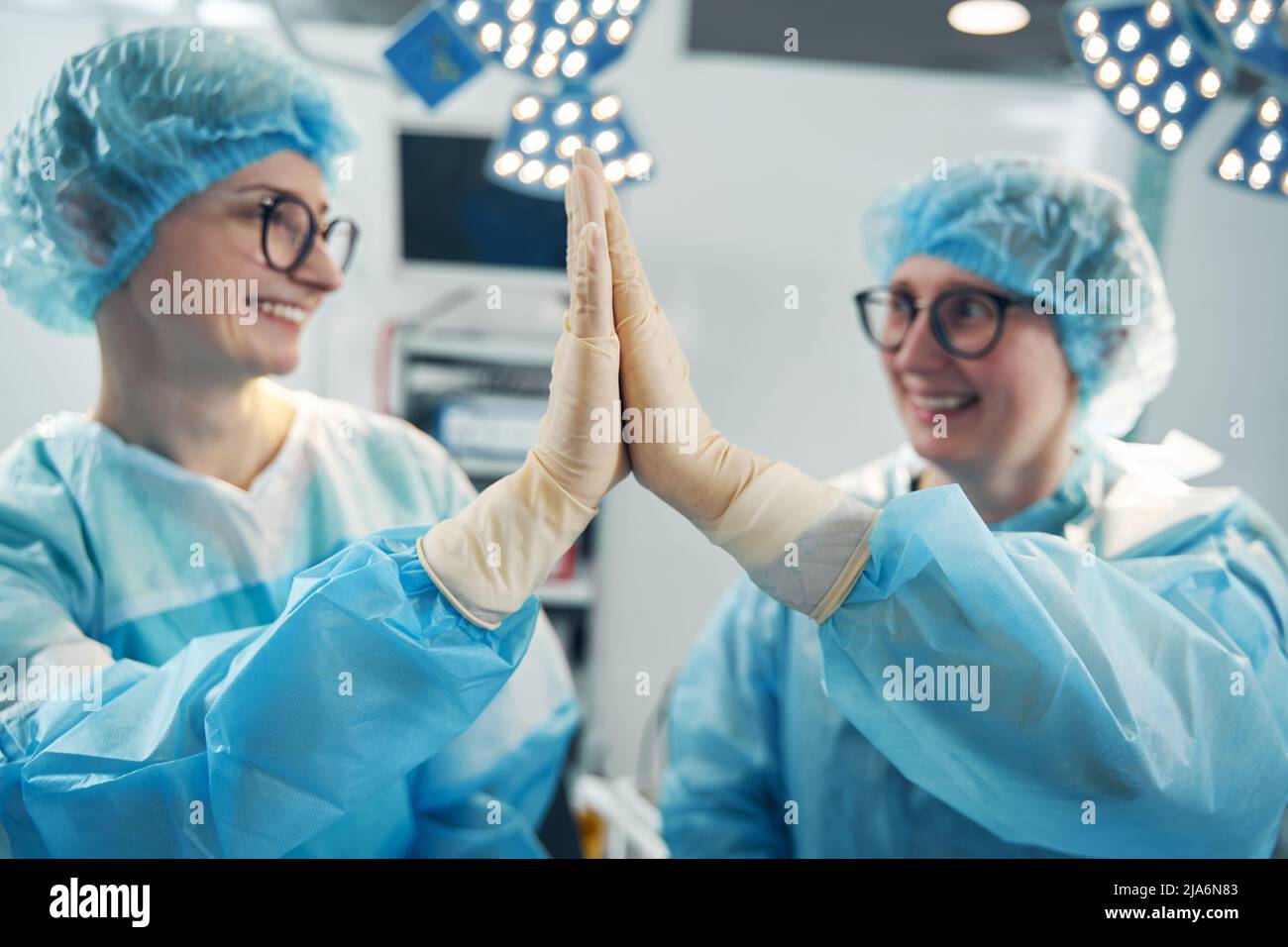 Cheerful nurses slapping their palms in high five Stock Photo