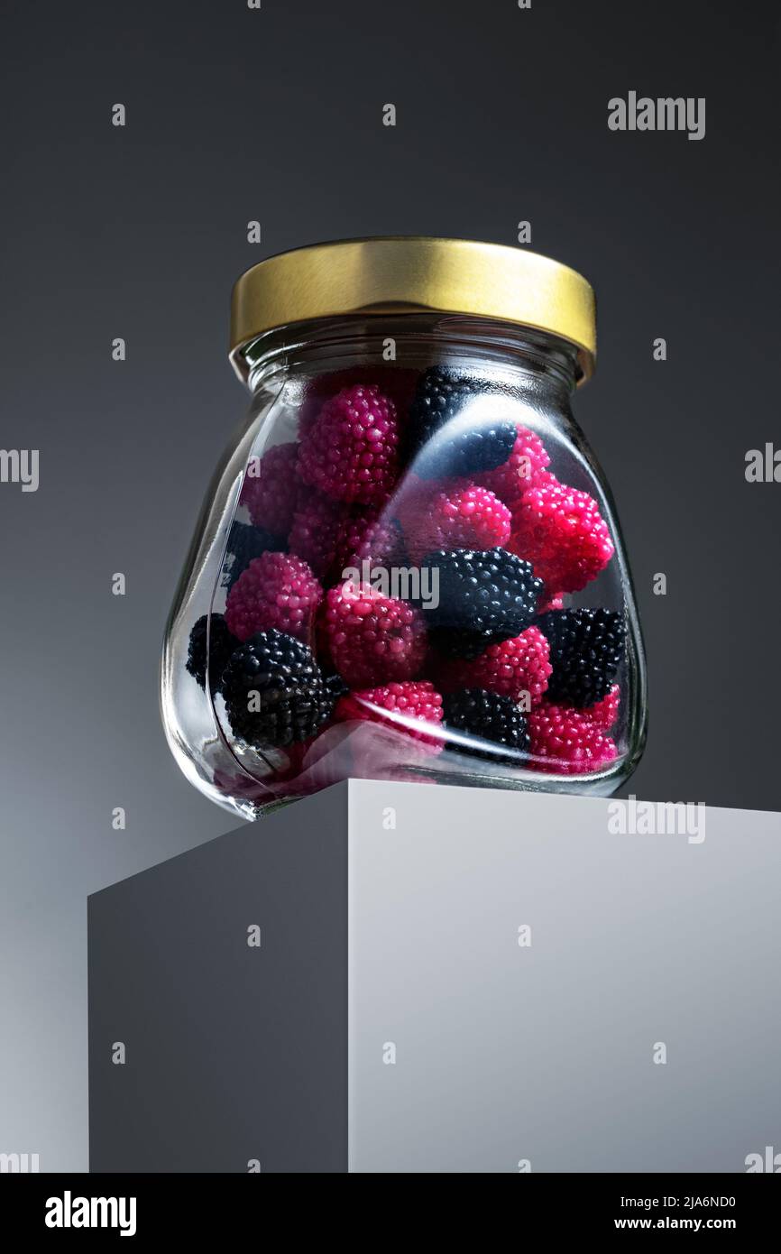 Presentation of blackberry shaped sweets packaged in a jar Stock Photo