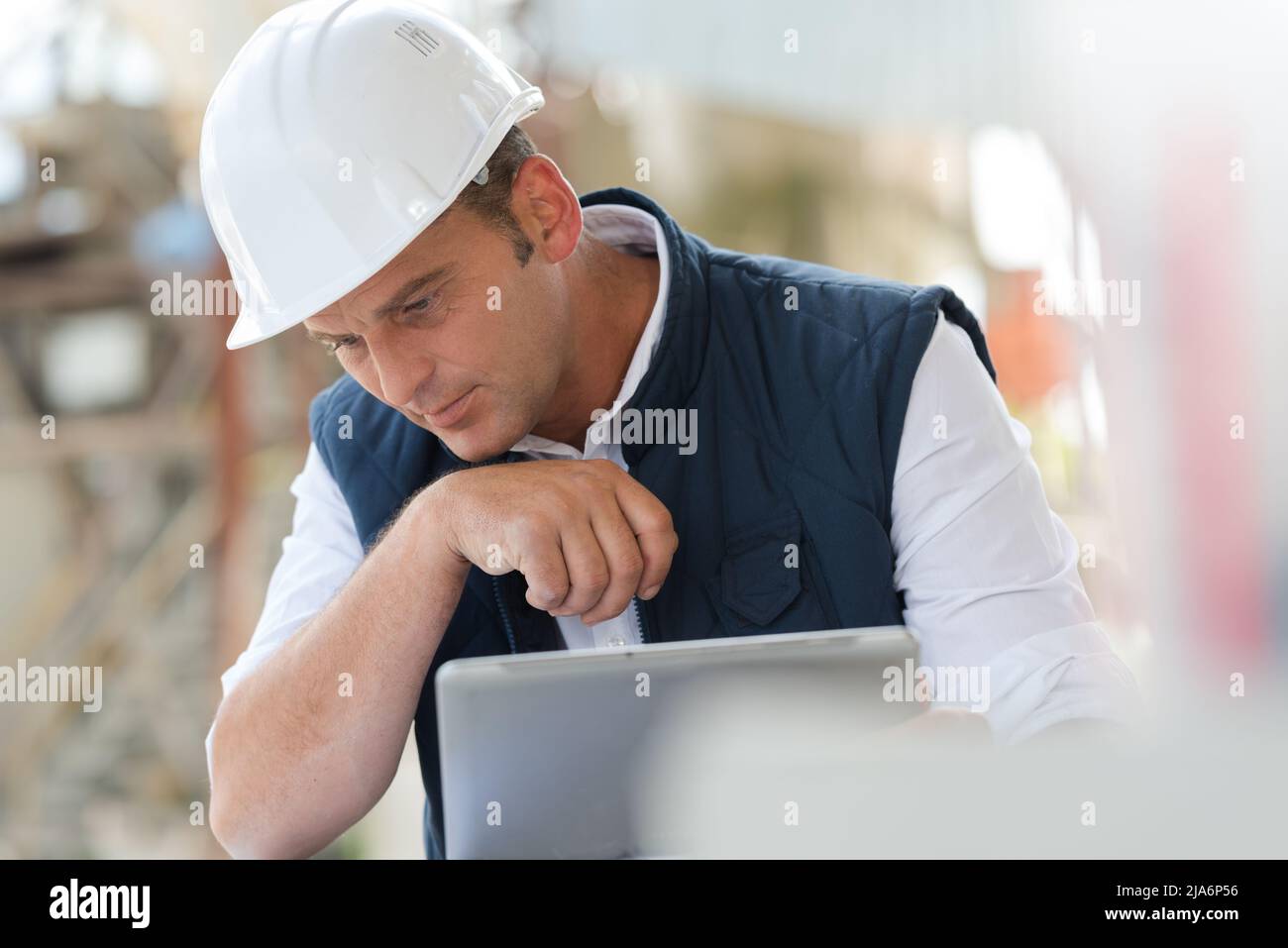 handsome male engineer is using a notebook for work Stock Photo