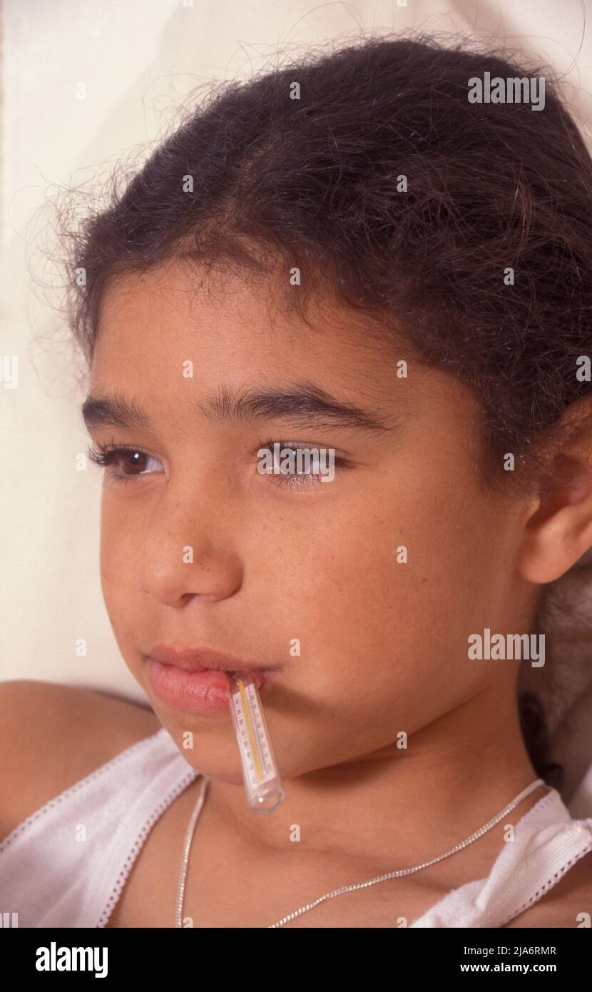 young girl with thermometer in mouth Stock Photo