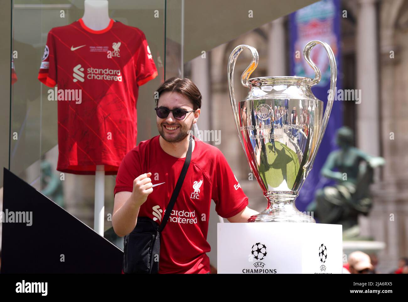A Liverpool fan poses with the Champions League trophy at the Trophy Experience held at the Hotel de Ville, ahead of the UEFA Champions League Final at the Stade de France, Paris. Picture date: Saturday May 28, 2022. Stock Photo
