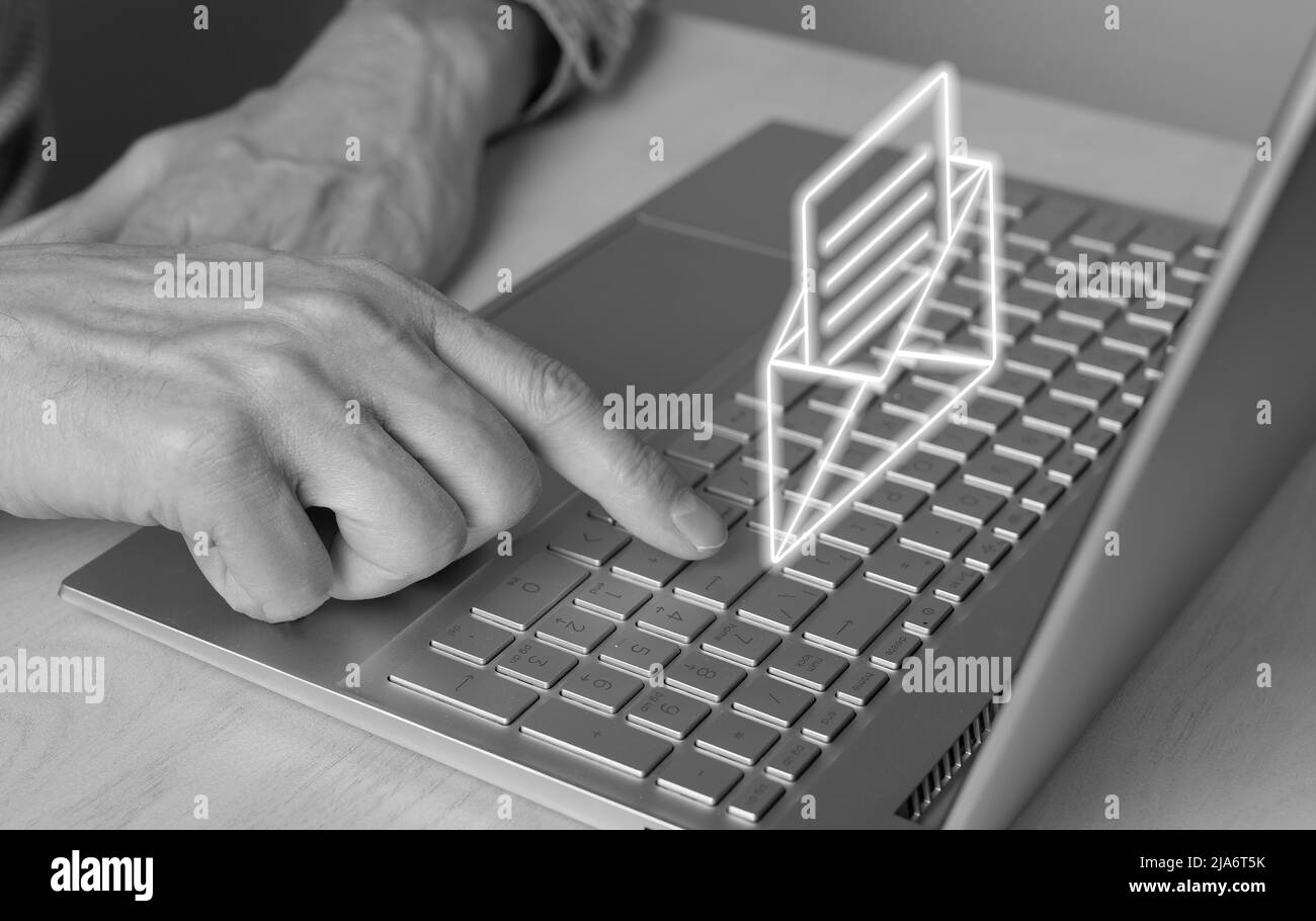 Spam email. Man forefinger pressing on enter button for blocking junk mail, unsolicited messages, ads for money scams. Black and white. Male working on laptop. High quality photo Stock Photo
