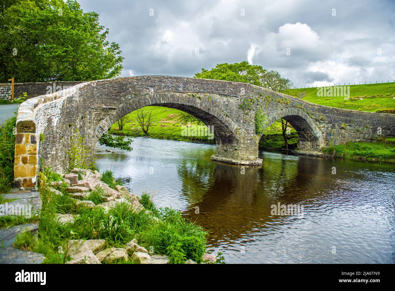 A possible 16th Century bridge crossing the River Lune at Firbank on its way to Lancaster - don't try it in a car!! Stock Photo