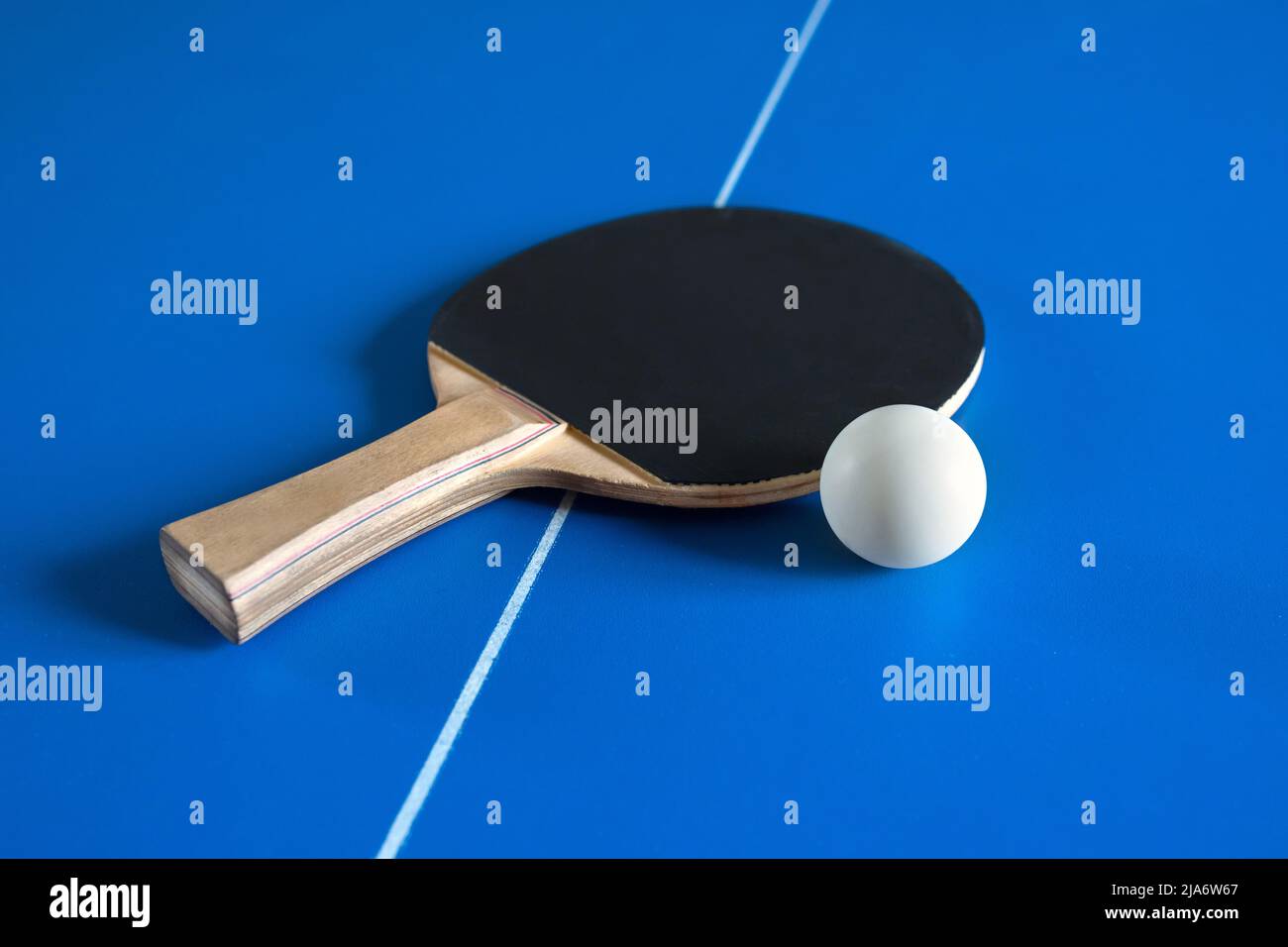 A tennis racket and a ball on the table. A sport game. Stock Photo