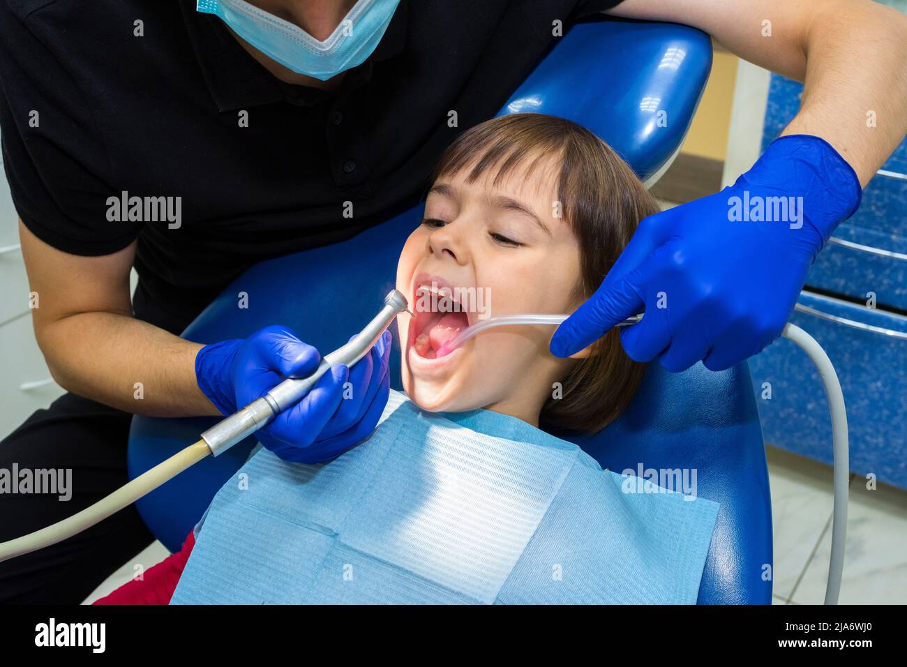 Stomatologist treating teeth of the child of the patient. Medicine