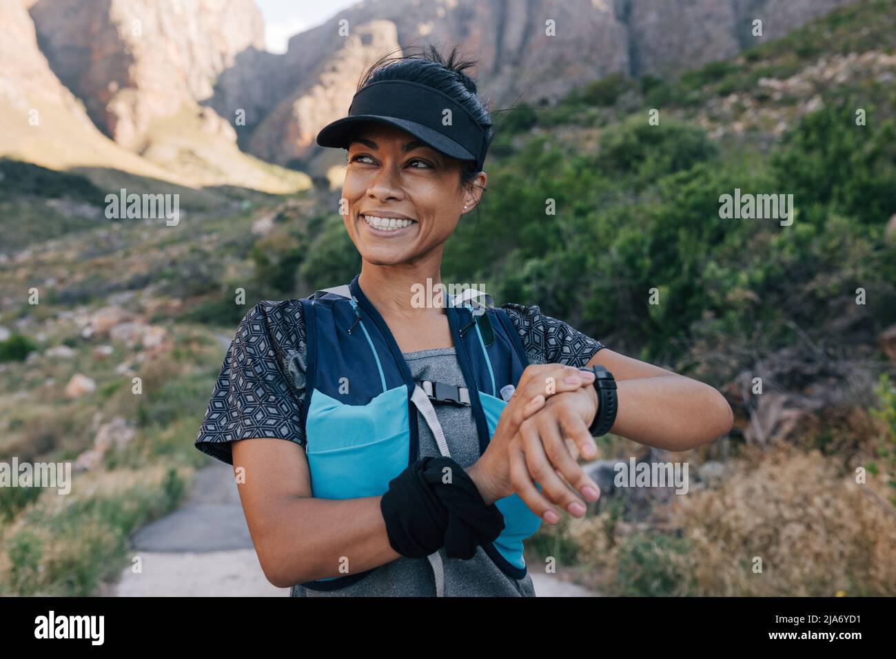 Portrait Of Healthy Trail Runner Checking Smart Woman In
