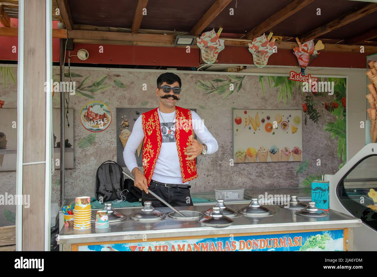The Turkish Ice cream street vendor sporting traditional dress and moustache. Stock Photo