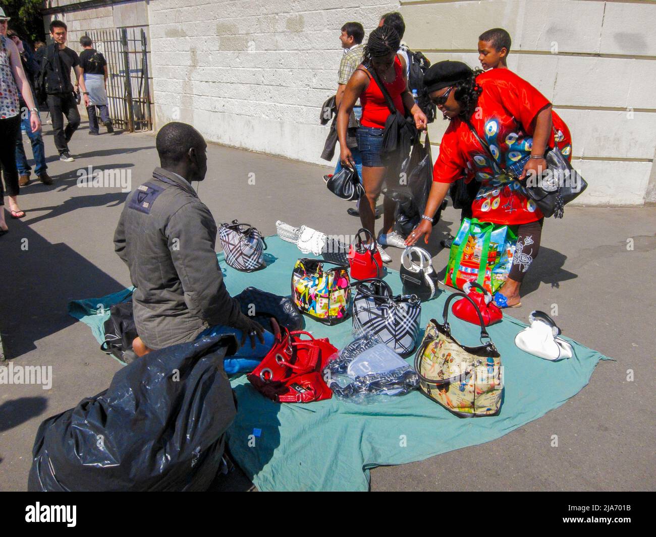 Paris, France, street vendors, Tourists Visiting Montmartre, African Man selling Handbags on Sidewalk Stock Photo