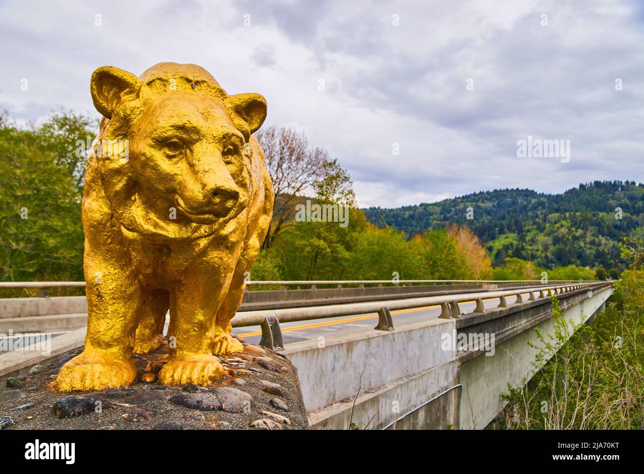 Bridge marked with giant gold bear statue at entrance Stock Photo