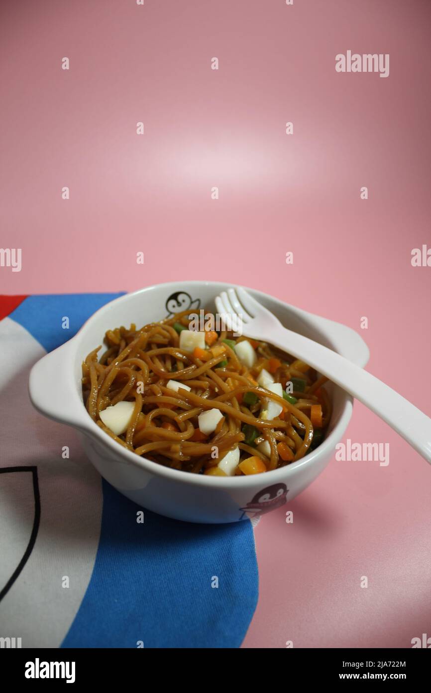 Fried Noodle in the bowl with toping Stock Photo