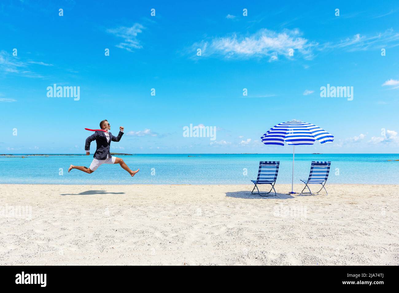 Happy businessman running from the work on the tropical beach. Summer vacation concept. Stock Photo