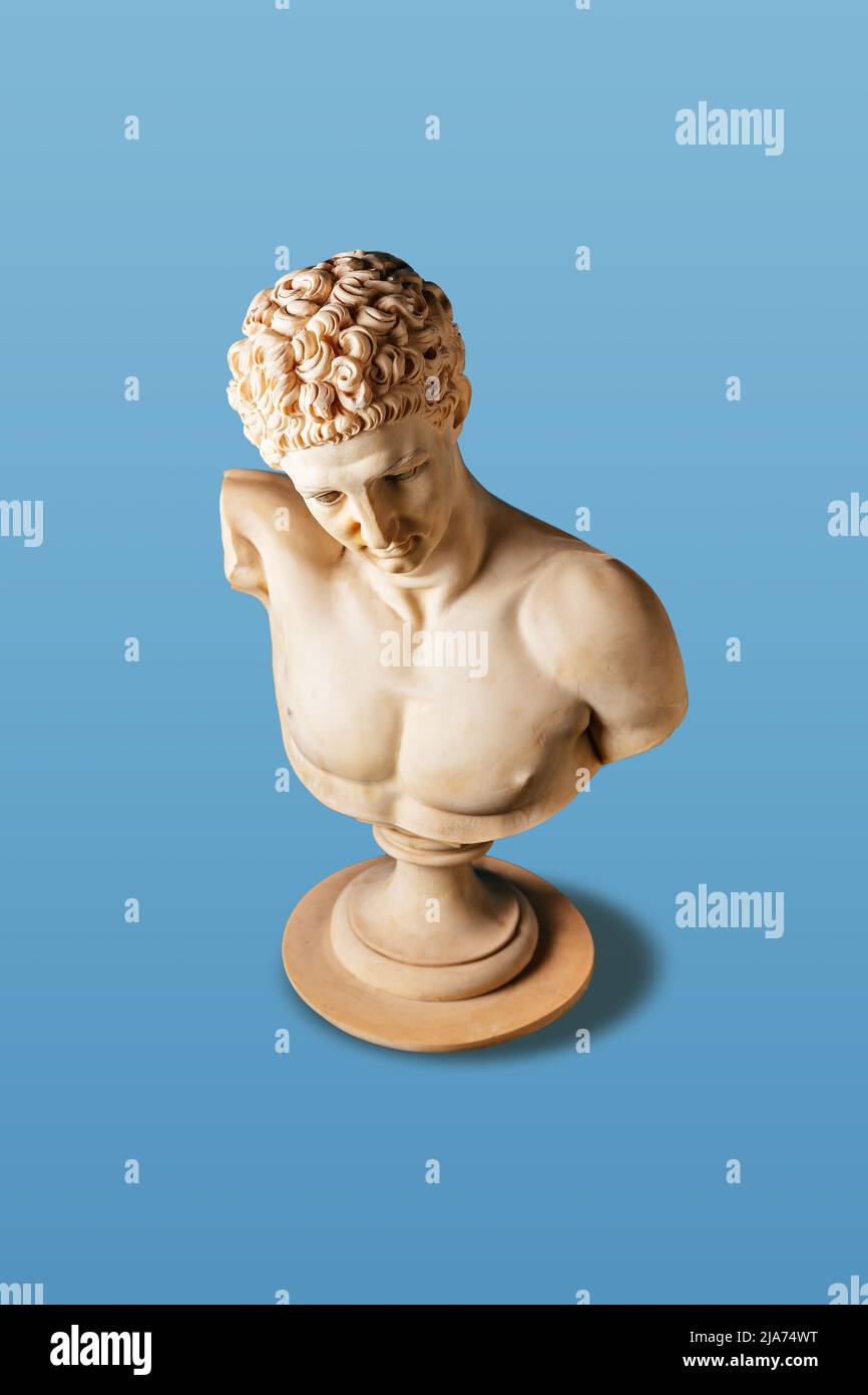 Top view of old statue on light blue background. Minimal art concept. Stock Photo