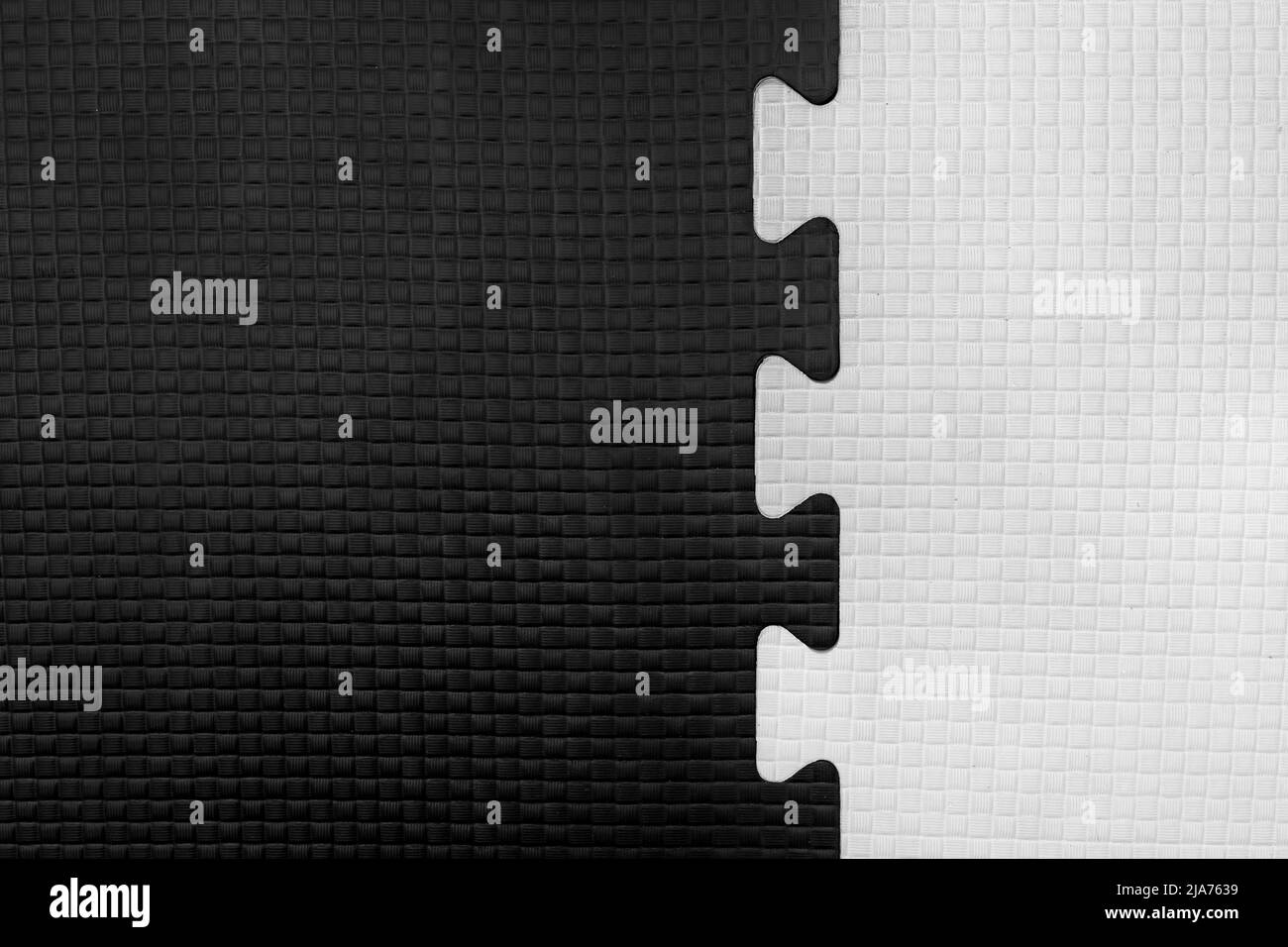 White and Black Puzzle Rubber Mat Pattern Gym Floor Background Abstract Design. Stock Photo