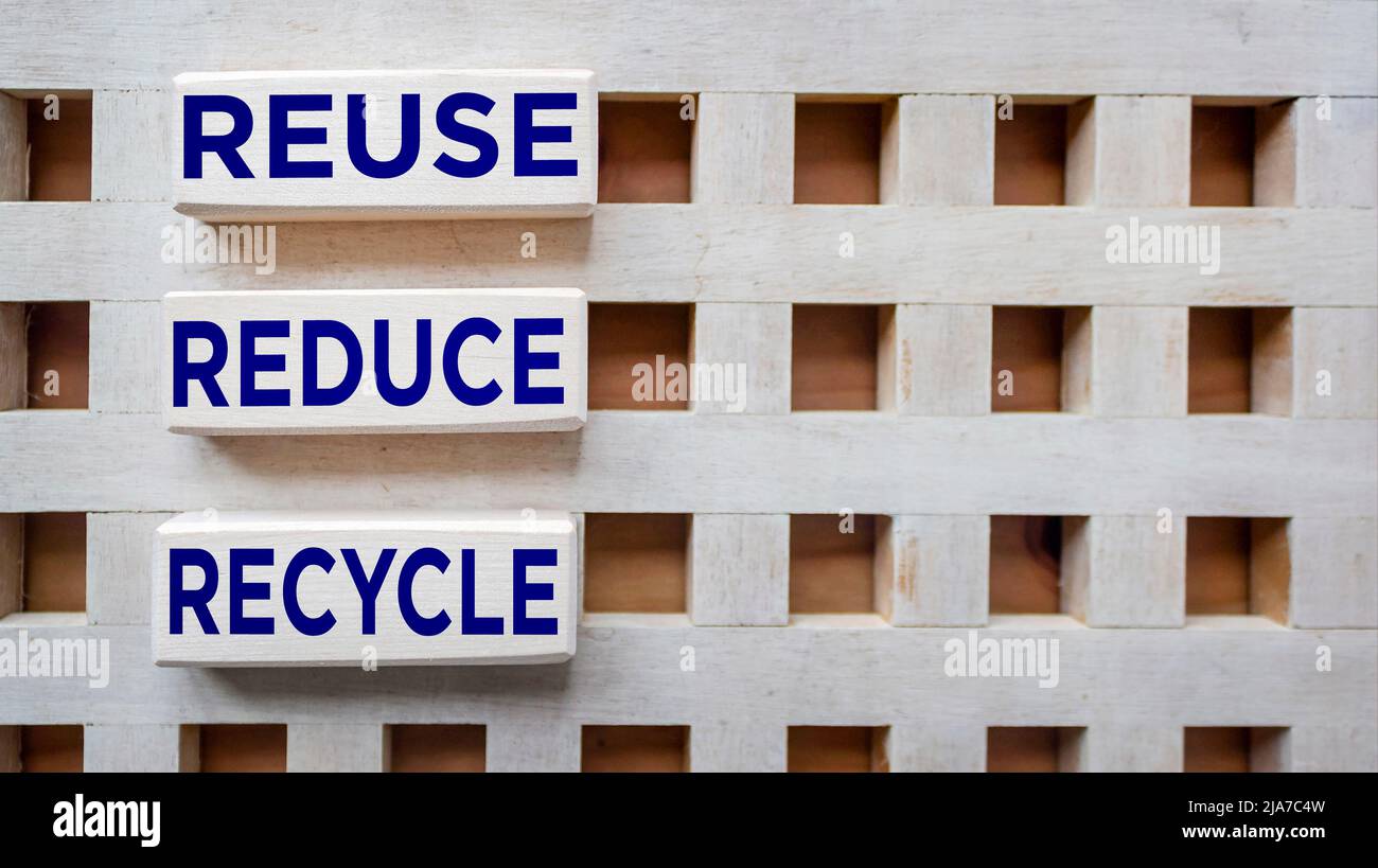 Environmental awareness and educational concept. REUSE, REDUCE and RECYCLE written on wooden blocks. Stock Photo