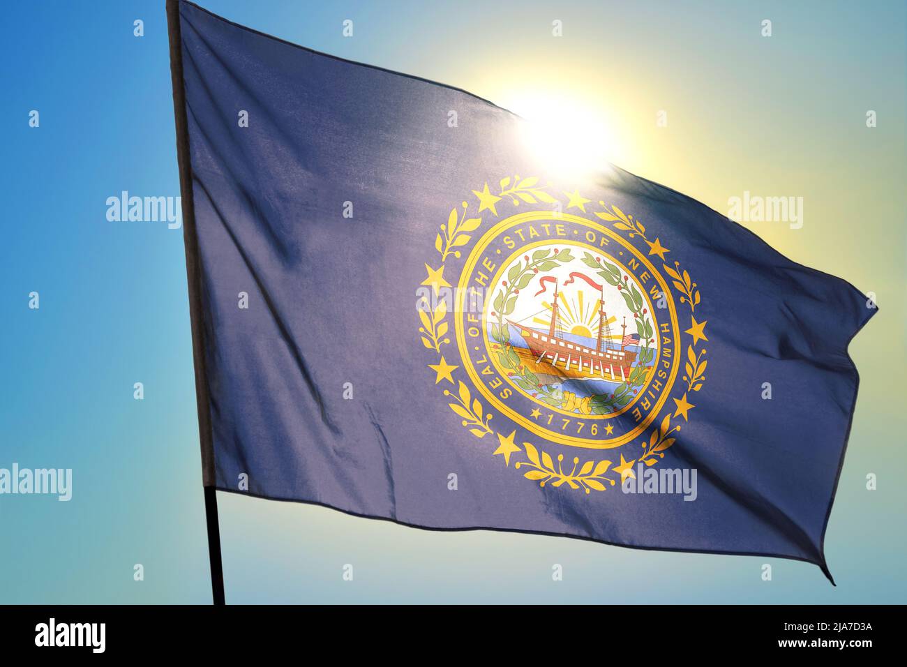New Hampshire state of United States flag waving on the wind Stock Photo