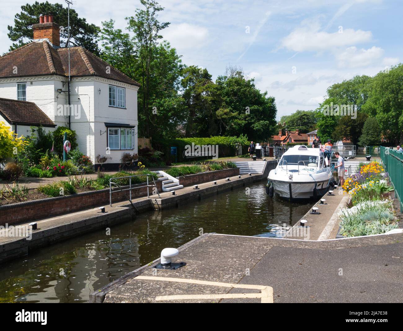 River cruiser in Marlow Lock on River Thames Marlow Buckinghamshire England UK with lock filling for boat to travel on to Henley Stock Photo