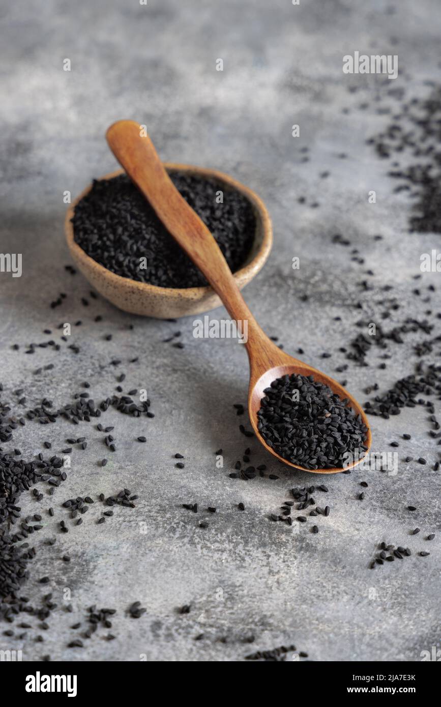 https://c8.alamy.com/comp/2JA7E3K/bowl-of-indian-spice-black-cumin-nigella-sativa-or-kalonji-seeds-on-grey-table-with-a-wooden-spoon-close-up-with-copy-space-traditional-asian-medi-2JA7E3K.jpg