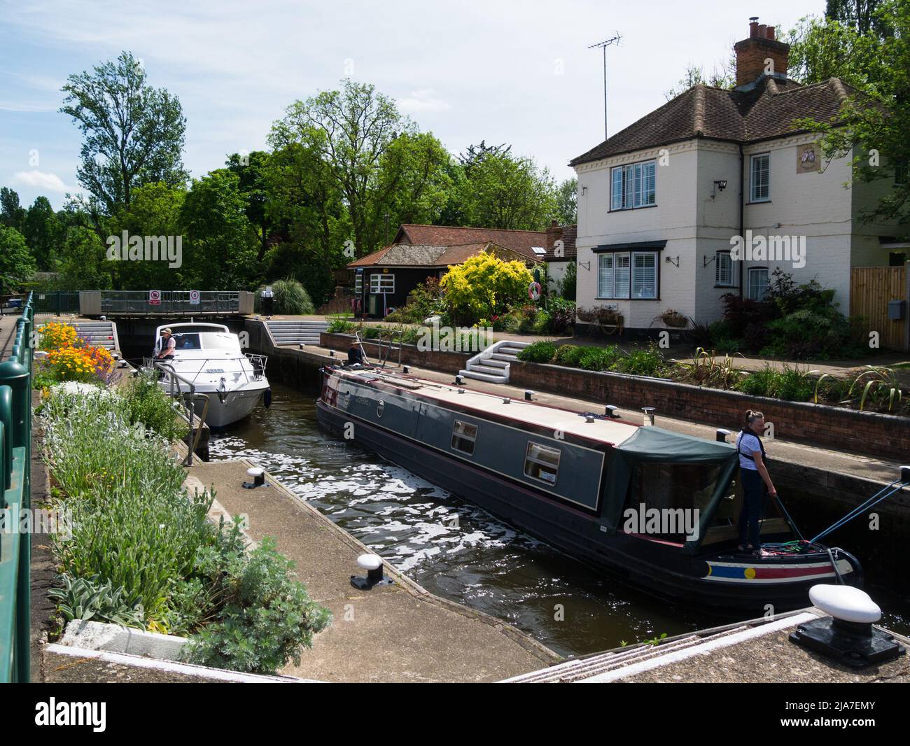Narrowboat and river cruiser in Marlow Lock with gates closed waiting for lock to fill before proceeding towards Marlow Buckinghamshire England UK Stock Photo