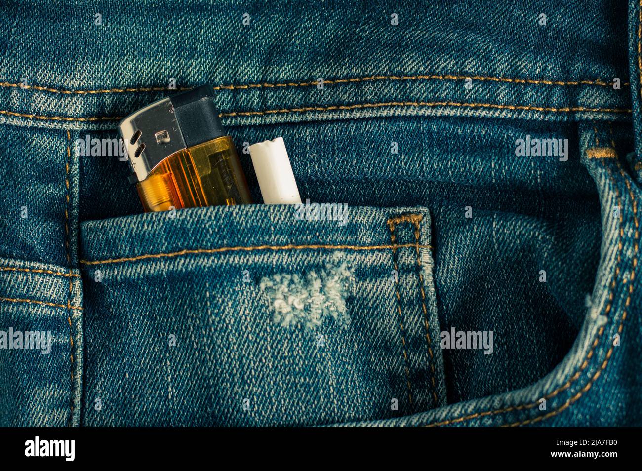 lighter and cigarette put in jeans pocket Stock Photo Alamy