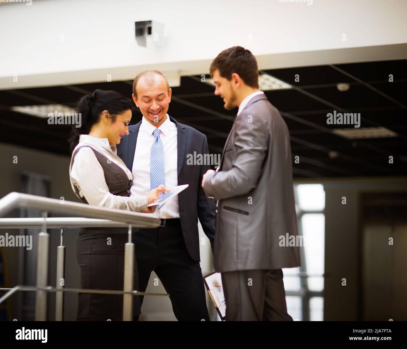 smiling business team discussing something in office Stock Photo
