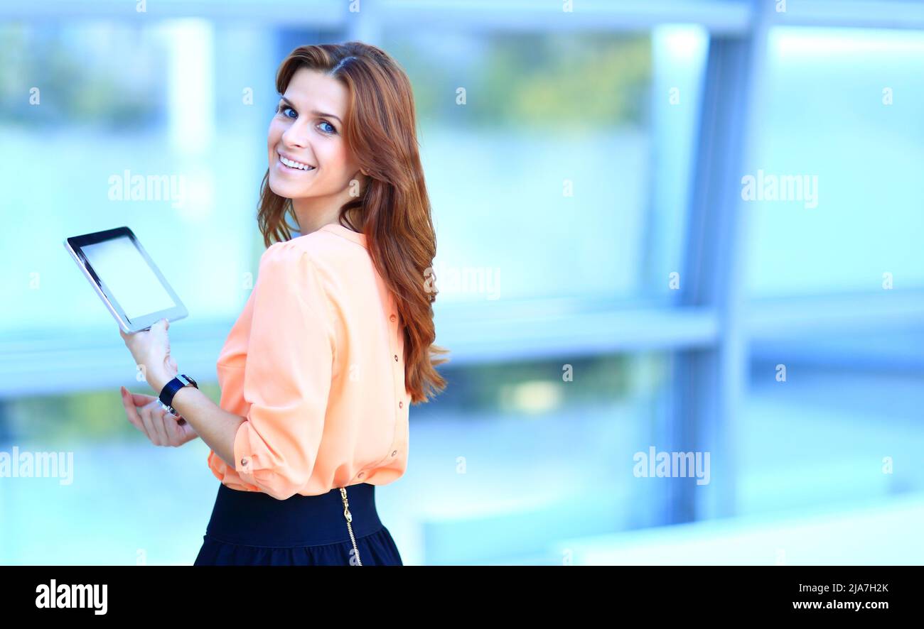 Handsome businesswoman using his digital tablet Stock Photo