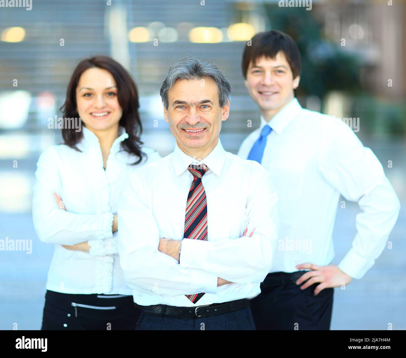 Successful business group in a row smiling Stock Photo - Alamy
