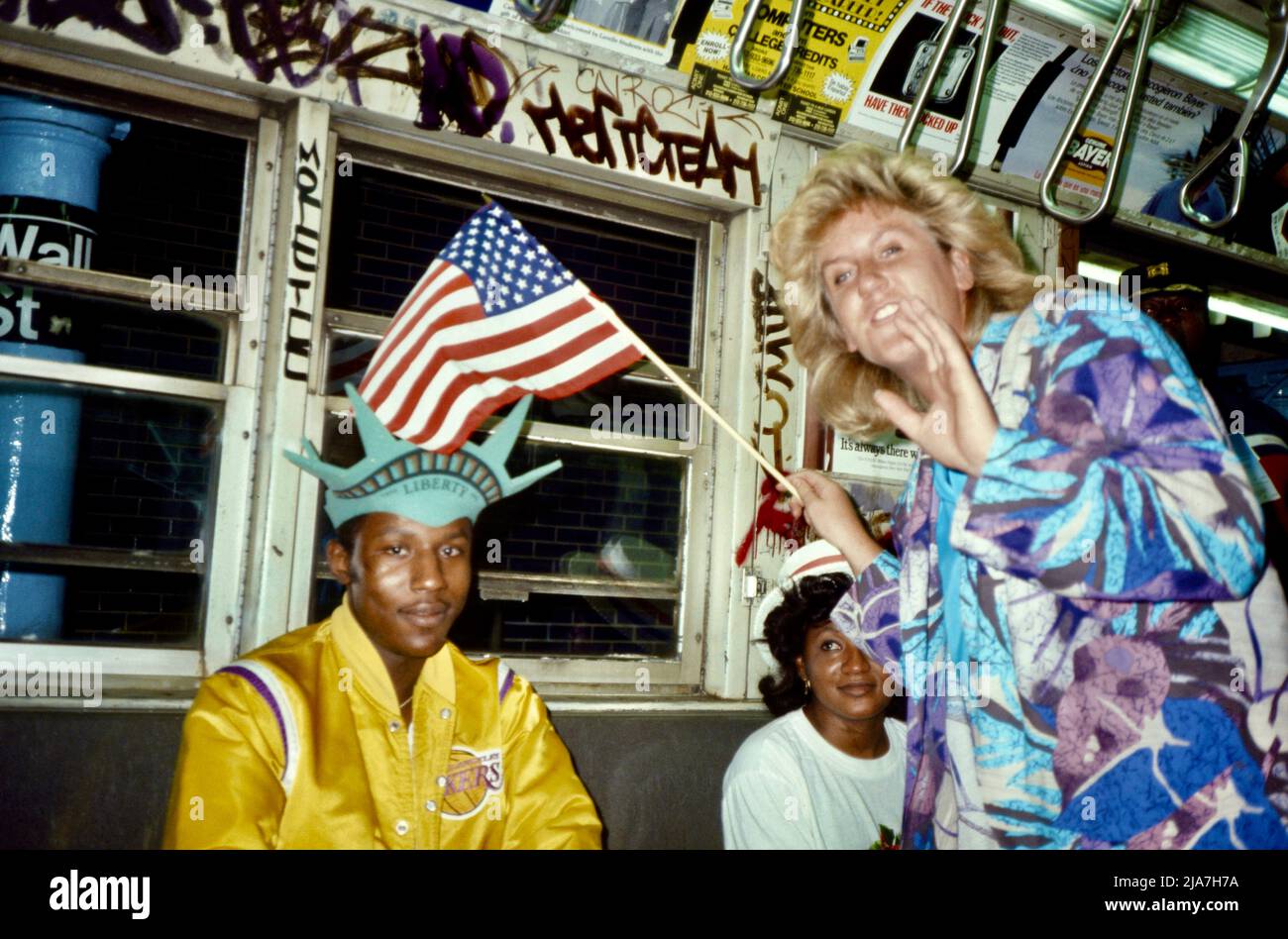 People celebrating the Statue of Liberty 100 year anniversary in New York subway car after the celebration. New York City 1986 Stock Photo