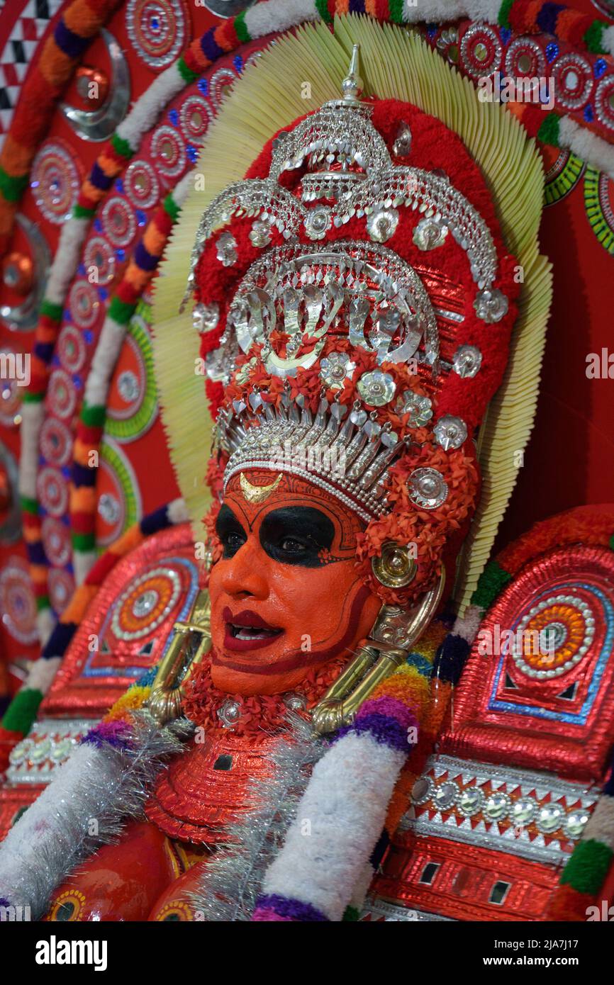 Theyyam is a famous ritual art form in kerala with face painted using organic colors and use musical instruments as Chenda, Elathalam, , Kurumkuzal Stock Photo