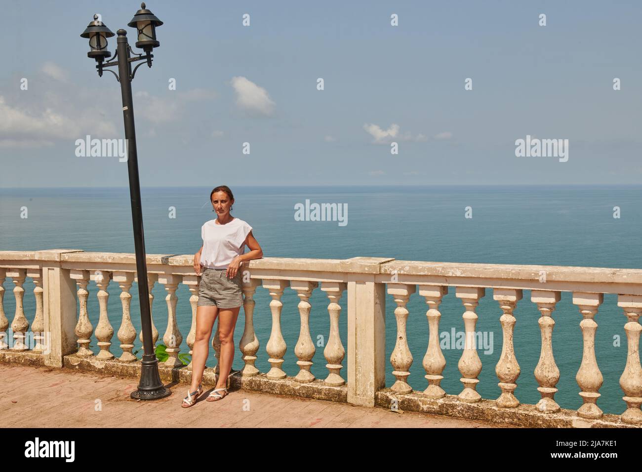 one girl stands on the embankment in Batumi Stock Photo - Alamy