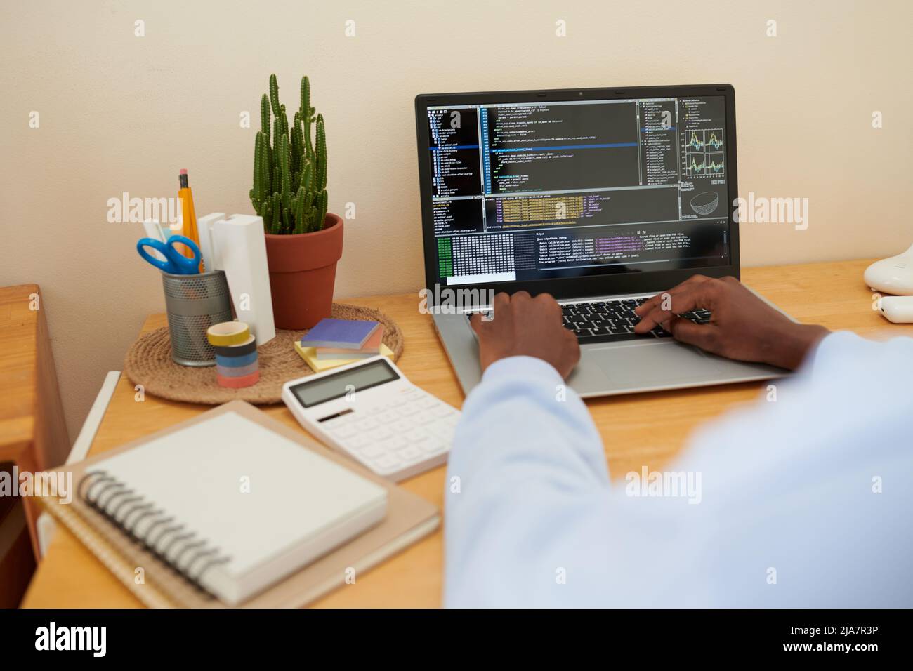 Female college student coding on laptop when working on project for ...