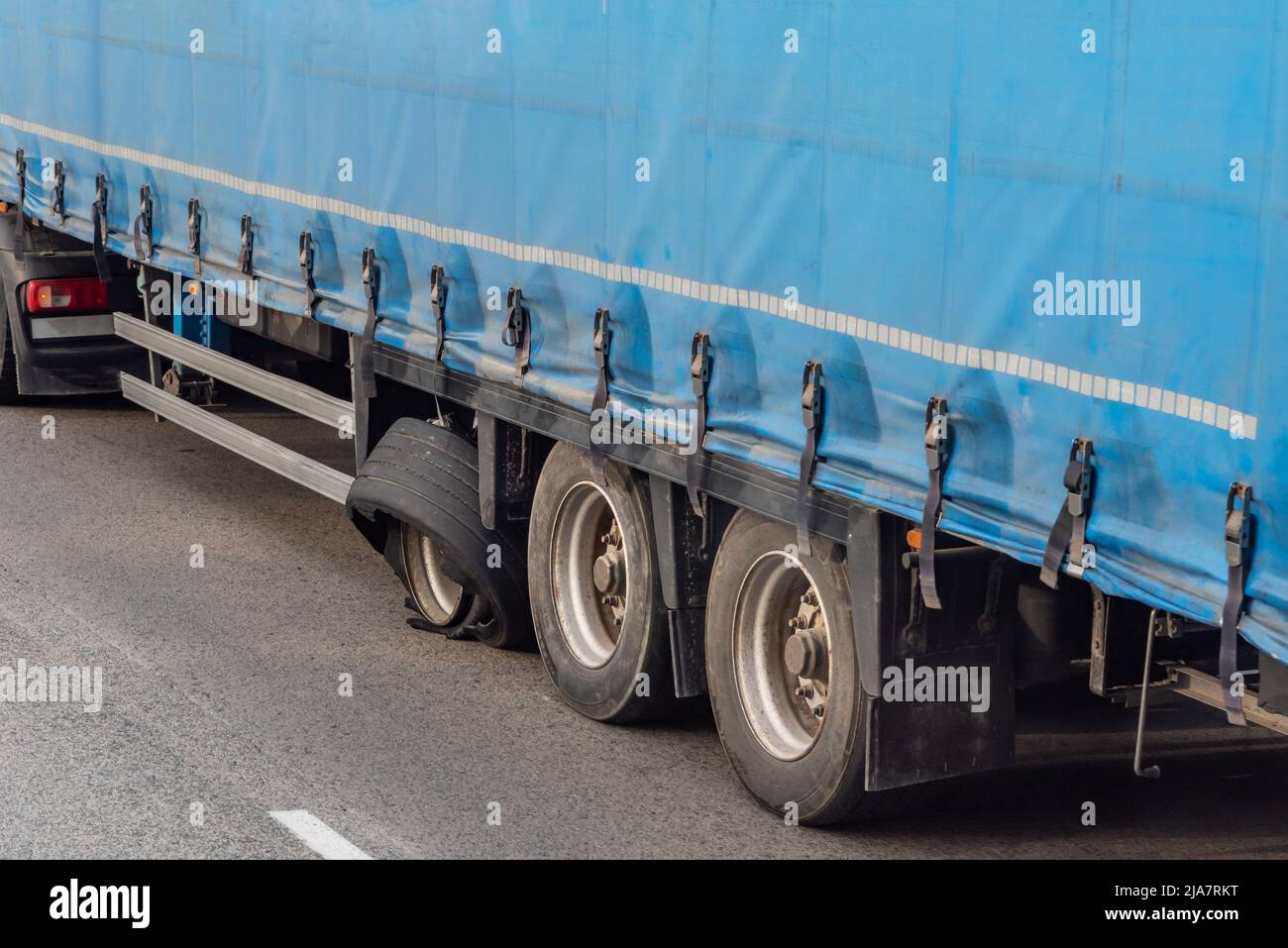 Semi-trailer wheel of a busted truck. Stock Photo