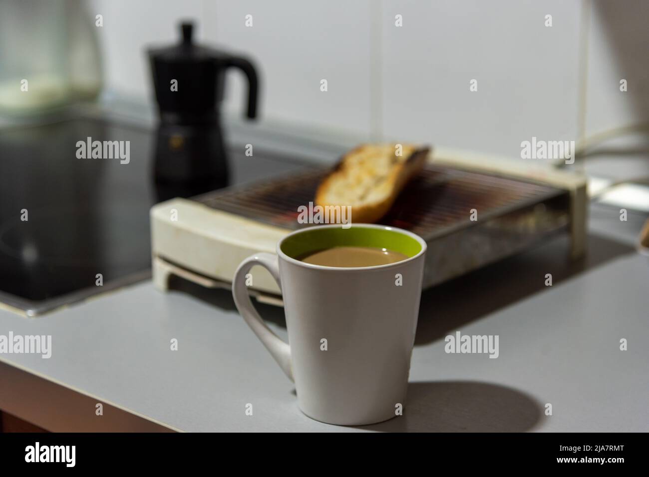 https://c8.alamy.com/comp/2JA7RMT/cup-of-coffee-with-milk-on-the-kitchen-counter-2JA7RMT.jpg