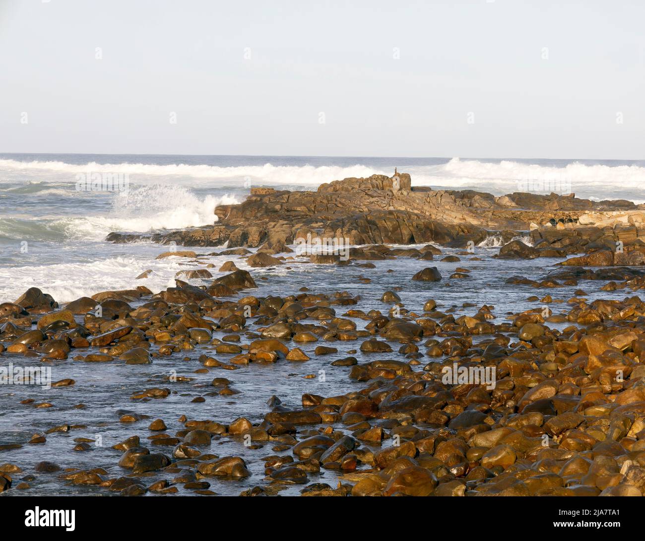 Sea water washing against the rocks at the costal region of Mossel Bay on the Garden Route of South Africa Stock Photo