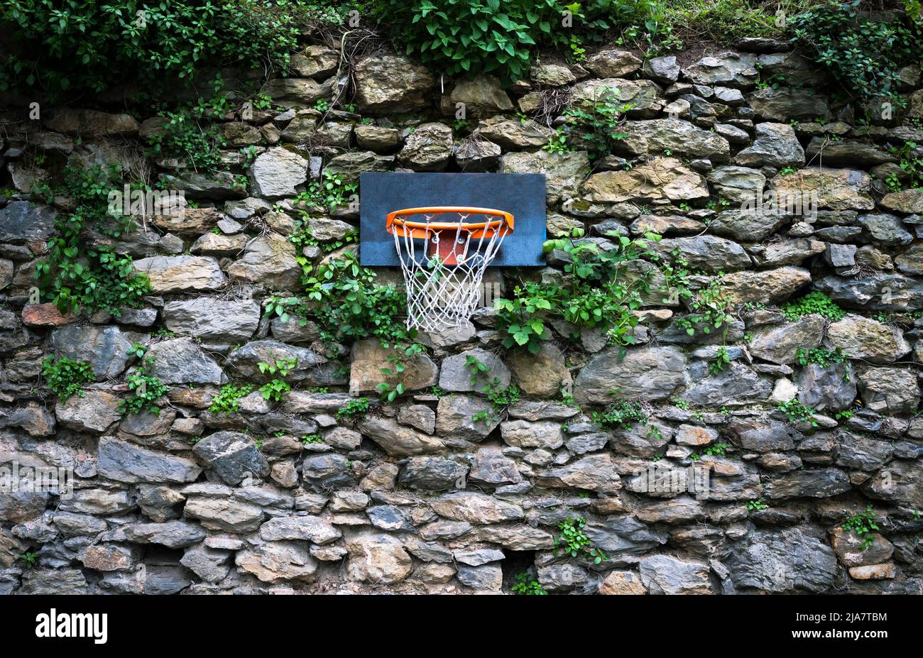 basketball hoop on stone wall Stock Photo Alamy