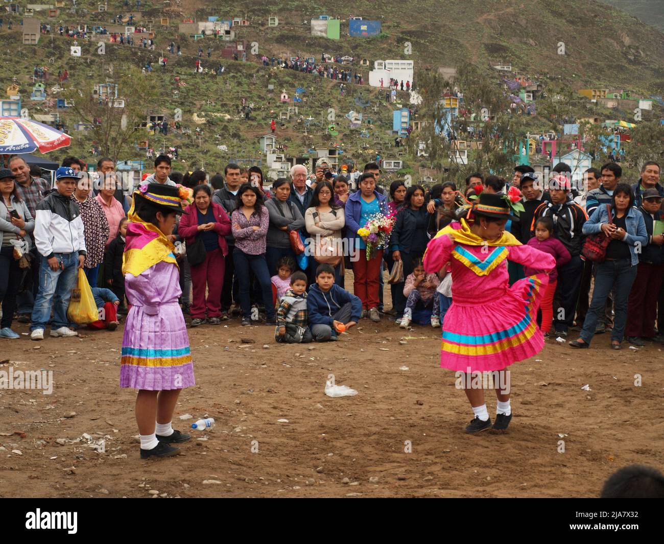 Peasants dancing for their dead relatives at the cemetery of Nueva Esperanza, in the district of Villa el Salvador in Lima. It is one of the largest in the Americas and receives almost two million visitors each year, only on the day of the dead. Stock Photo