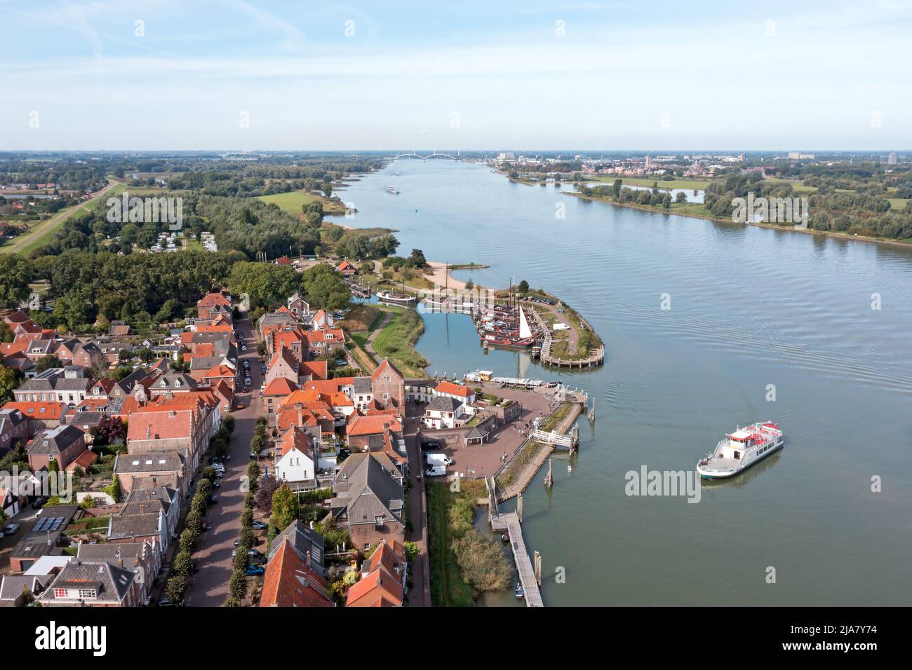 Aerial from the historical village Woudrichem with the ferry arriving in the Netherlands Stock Photo