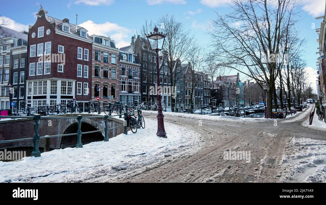 City scenic from a snowy Amsterdm in winter in the Netherlands Stock Photo