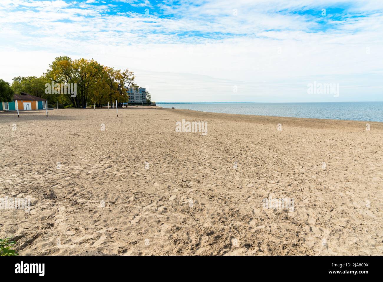 Large beach on a lake on a partly cloudy autumn day Stock Photo