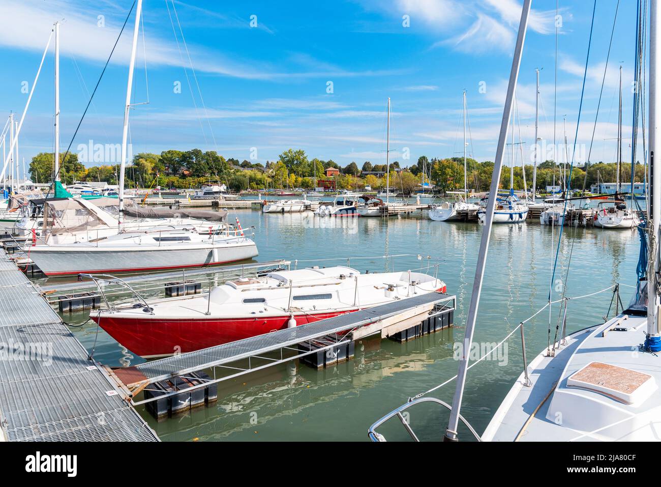 Yachts in harbour in bright sunshine in autumn Stock Photo