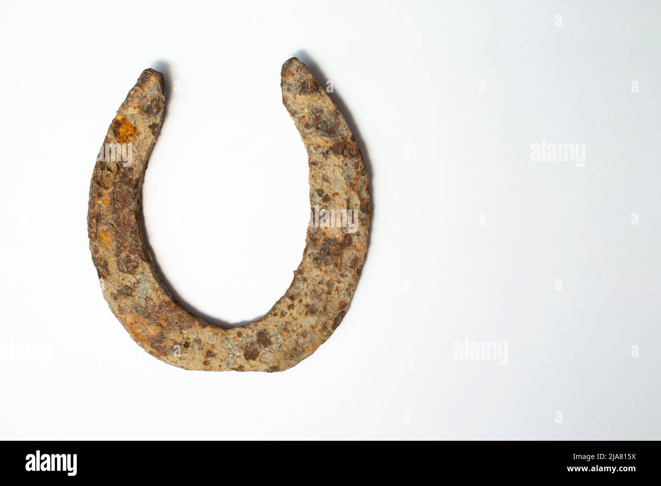 Rusty corroded horse shoe isolated on white background Stock Photo